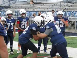 Youth football players practicing